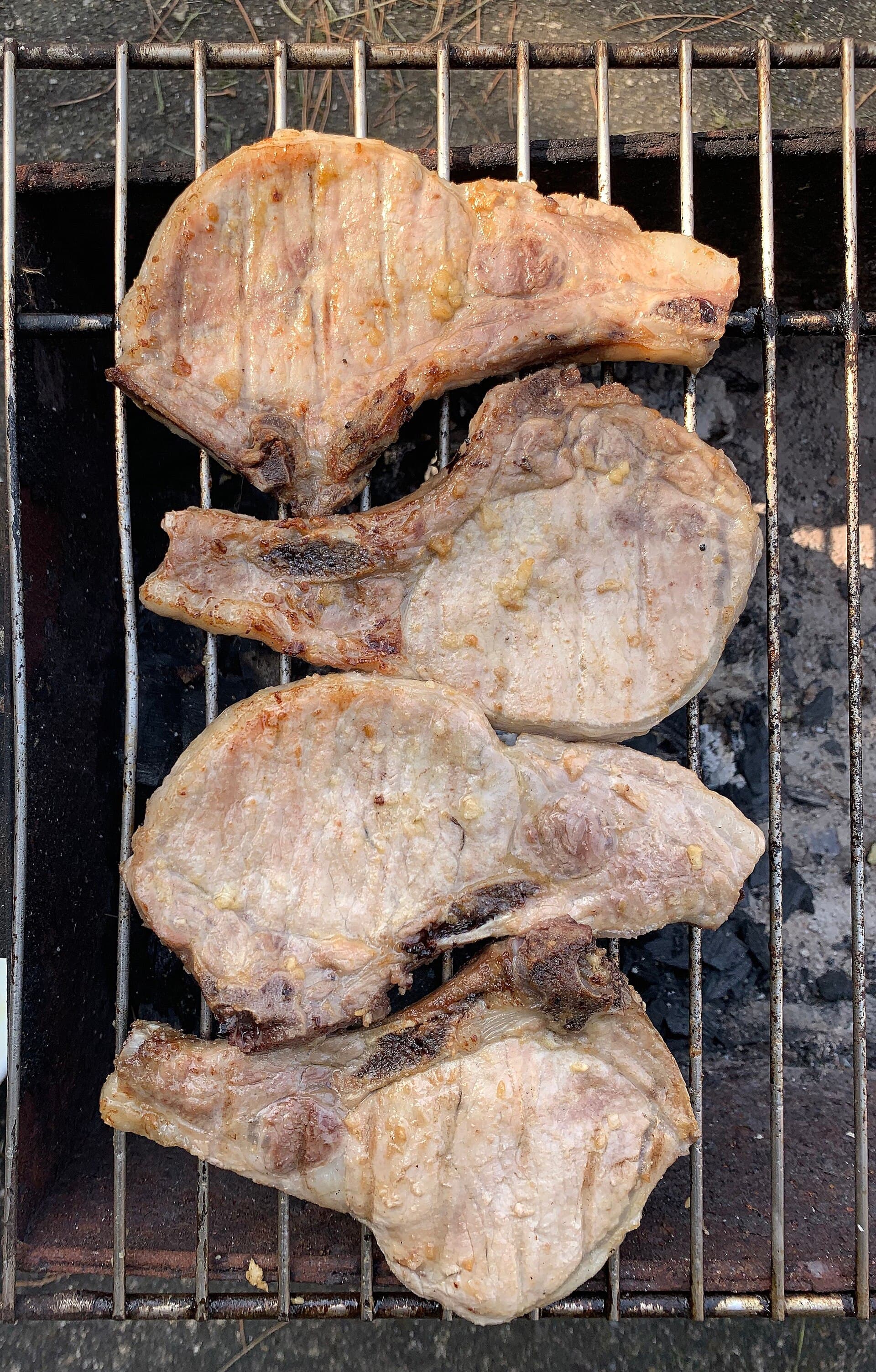 Marinated pork chops cooked on a barbecue grate