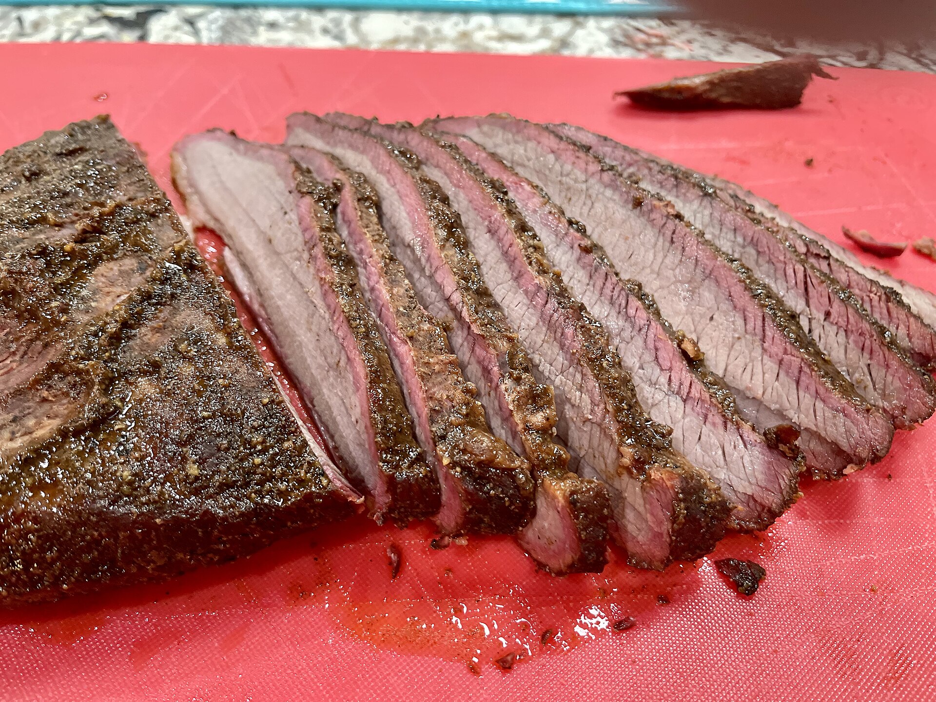 Sliced smoked brisket with a smoke ring